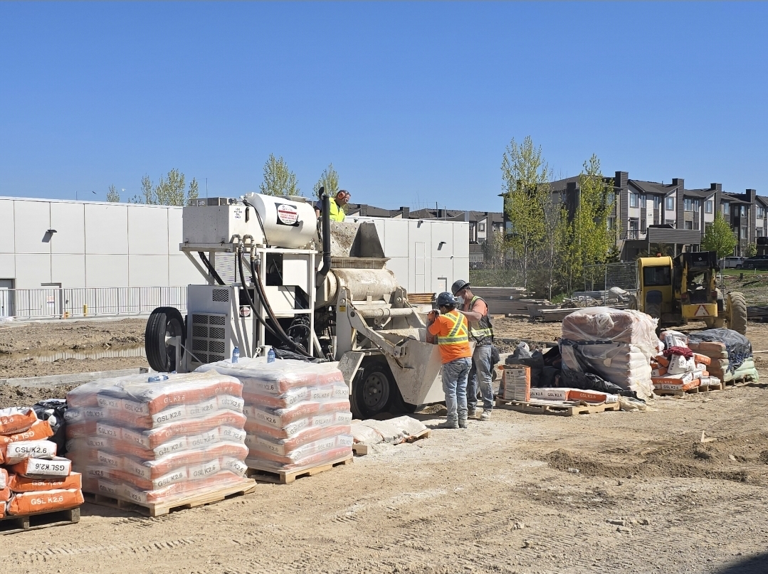 FloLayer crew pumping gypcrete underlayment at a job site