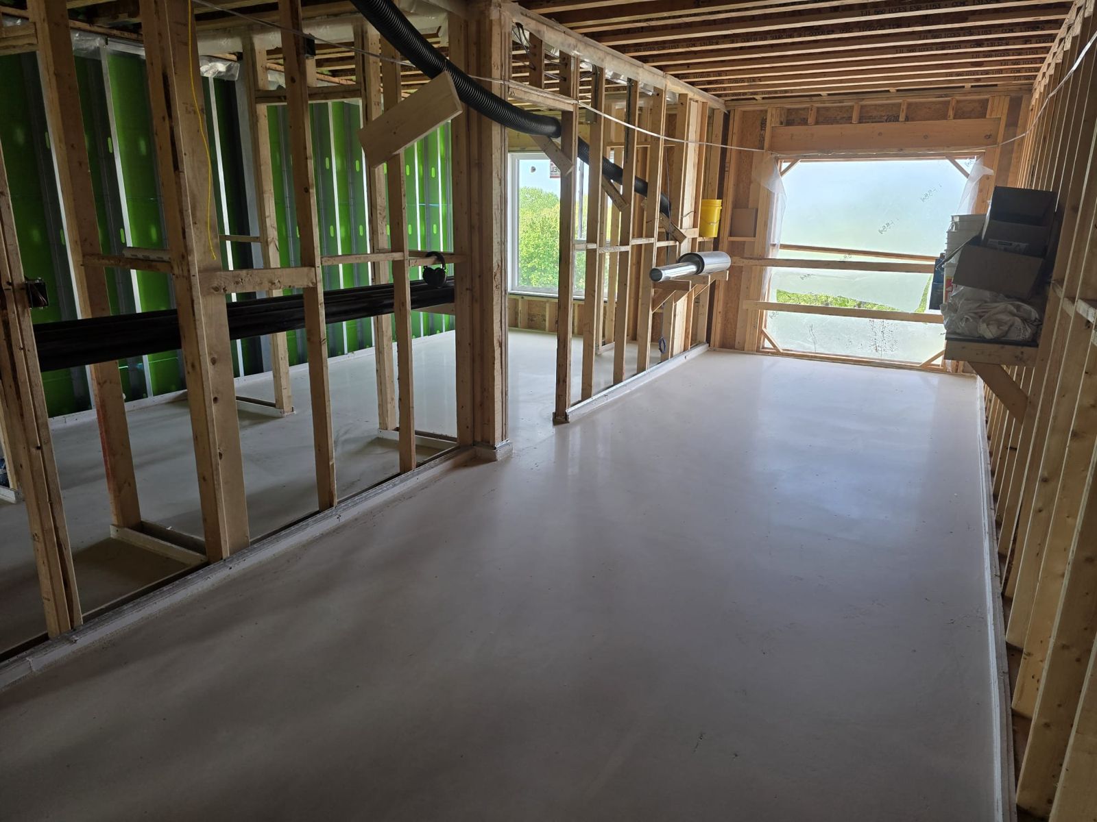 Freshly poured self-leveling floor in a wood-frame building with insulated walls
