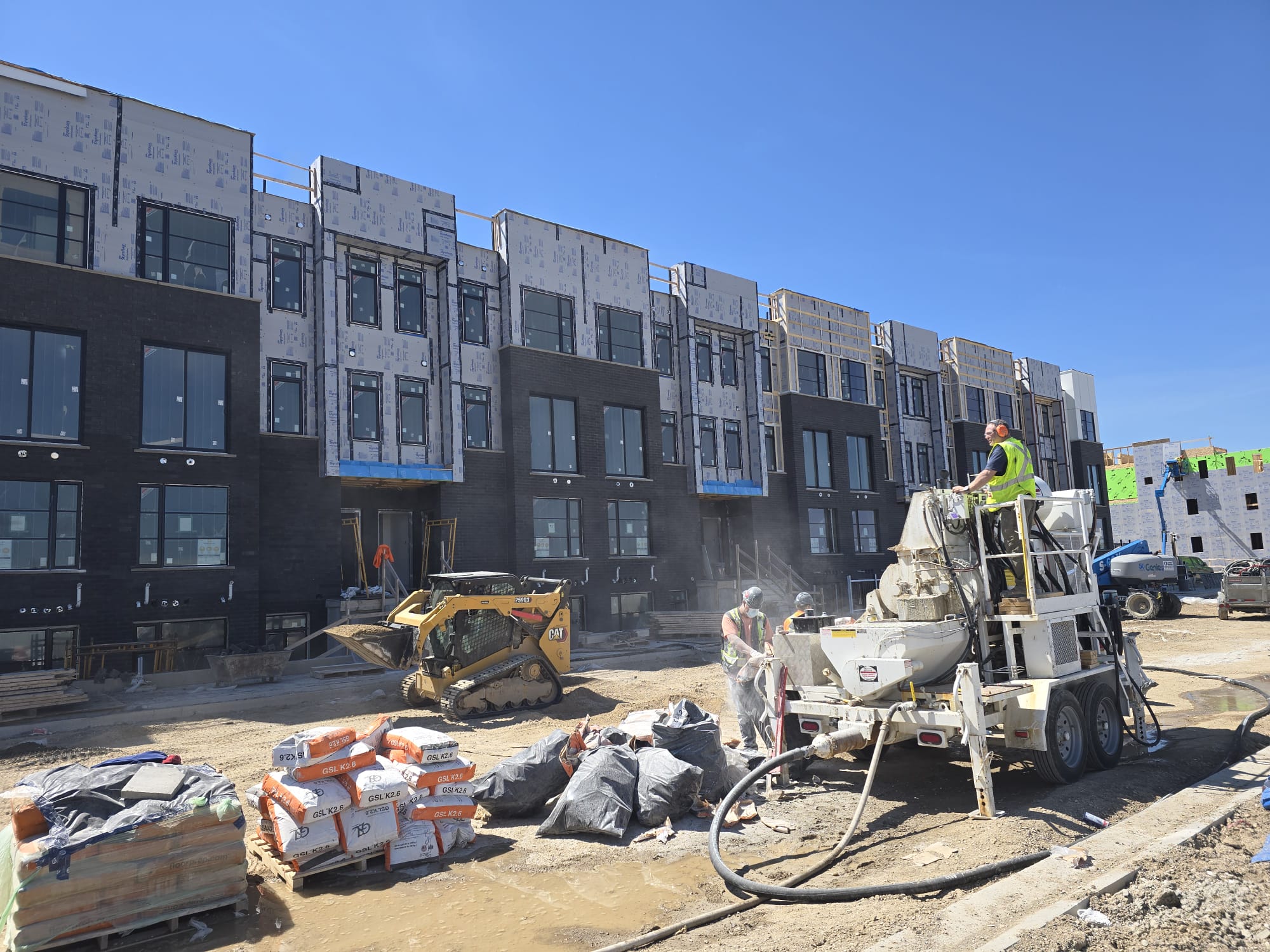 FloLayer pump truck and equipment at townhouse construction site